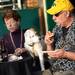Michigan fan Glenn Shelley, of Adrian, tempts his dog Cooper with a bite of pizza as they eat outside before the start of the Outback Bowl New Year's eve parade in Ybor City, Fla. on Monday night. Melanie Maxwell I AnnArbor.com